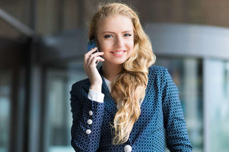 Portrait of a young woman talking on the phoneの写真素材