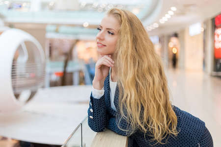Thoughtful businesswoman in a thoughtful expression in a bright mallの写真素材