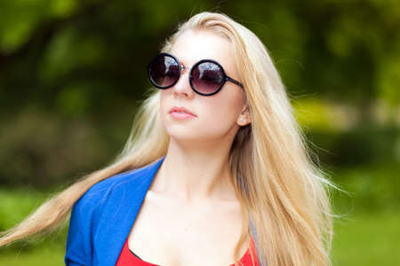 A beautiful blond girl in a parkの写真素材