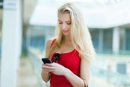 Young woman typing on the phoneの写真素材
