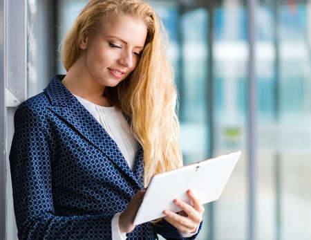 Smiling businesswoman using a digital tablet outdoorの写真素材