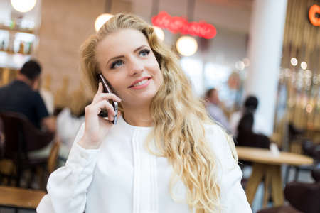 Portrait of a young woman talking on the phoneの写真素材