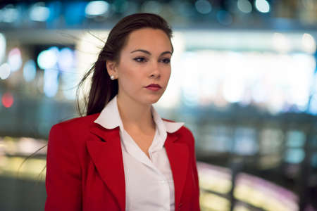 Business woman walking in city at night