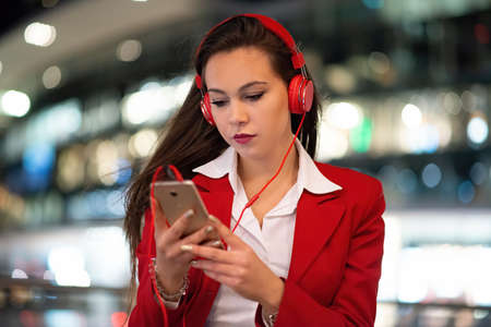 Woman listening music from her mobile phoneの写真素材
