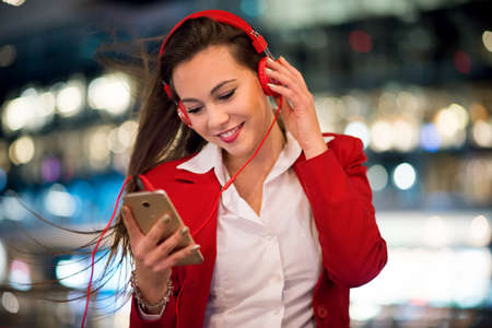 Woman listening music from her cellphoneの写真素材