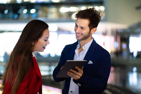 Couple of business people using a tablet outdoorの写真素材