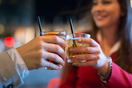 People toasting glasses at night