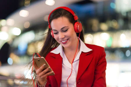 Woman listening music from her cellphoneの写真素材