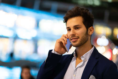 Young manager on the phone outdoor in an urban settingの写真素材