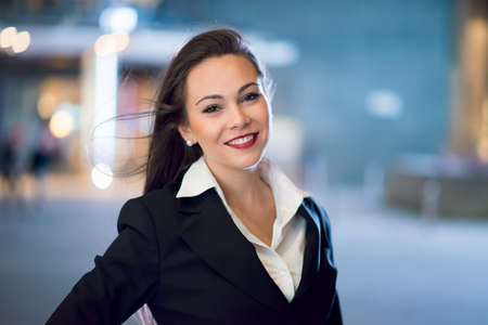 Young business woman portrait at night in a cityの写真素材