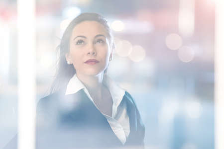 Portrait of a young business woman, double exposure effect. Businesswoman career