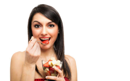 Woman eating a fruit cocktailの写真素材
