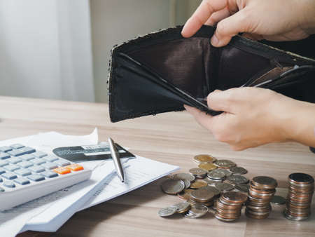 bankruptcy economic financial concept. Person open his empty wallet without money to pay debt in payday. lack of income and insufficient incomeの写真素材
