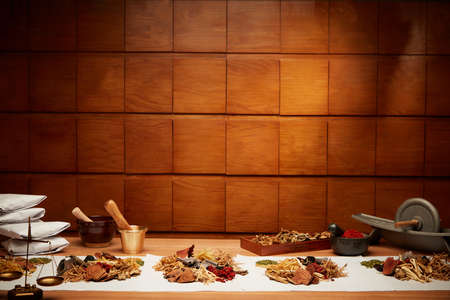 Traditional chinese herbal medicine. Ancient Chinese medicine and herbs on wooden tableの写真素材