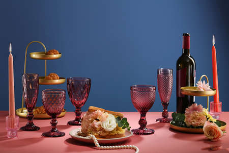 Beautiful wedding table decoration and wedding table setting with pink glass wine, candles, green...
