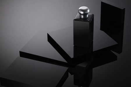 Blank Bottle Cosmetics on crystal black square podium background. Pedestal for display. Platform for design, concept blank scene stage showcase for new product, banner, promotion sale, event, museum.の写真素材