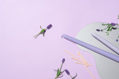 Fresh lavender with matches, candles and mirror on pastel background. Scene for product advertising with natural beauty from lavender. Copy space.の写真素材