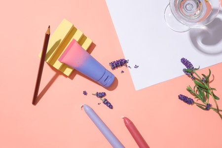 Creative cosmetics advertising scene with a mockup, lavender flowers and props on a pink background. Lavender extract is used in health and beauty.の写真素材