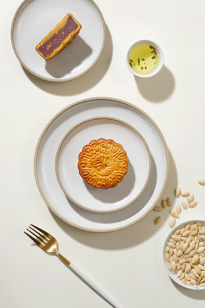 Traditional Chinese mid autumn festival, mooncakes on ceramic dishes and pumpkin seeds decorated on...