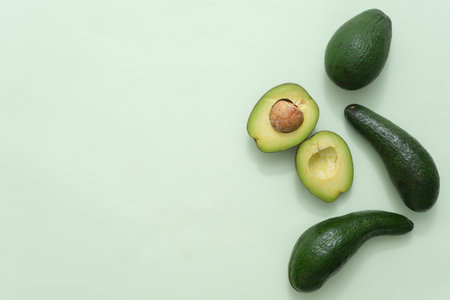 Minimal blank background with copy space for display cosmetic product. Fresh avocados and avocado...