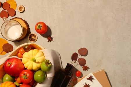 Many types of fruits are contained inside a basket with a towel. Anise and dried orange slices featured. Empty area for product promotionの写真素材
