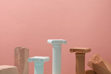 Some plaster statues and blocks of stone are arranged against pink background. Concept scene stage showcase for new product, promotion sale, cosmetic presentationの写真素材