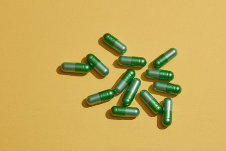 Top view of a lot of capsules pills on a yellow background. Sample vitamin b3, b5 tablets. Antibiotic drug resistance. Antimicrobial drug smart use.の写真素材
