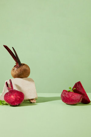 Over the pastel background, beetroot are arranged with a small block of rock. Vacant space in the middle to display product extracted from Beetroot (Beta vulgaris)の写真素材