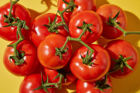 Creative cosmetics flat lay with tomato ingredient. Top view of fresh tomatoes with green petiole...