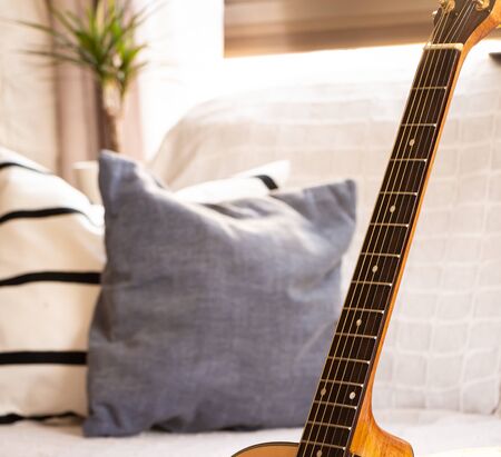 Acoustic guitar in an elegant living room. Selective focus.