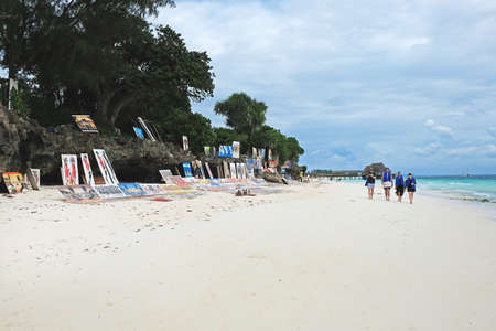 Zanzibar, Tanzania - July 13, 2018: Sale of souvenirs and paintings on the beautiful Kendwa beachのeditorial素材