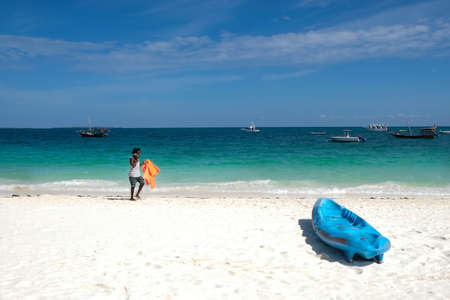Zanzibar, Tanzania - July 13, 2018: Black man on the beach amazing ocen romantic view Zanzibar coastのeditorial素材