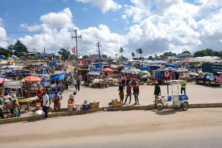 Dar es Salaam, Tanzania - July 9, 2018: People on a road bazaar in sunny dayのeditorial素材