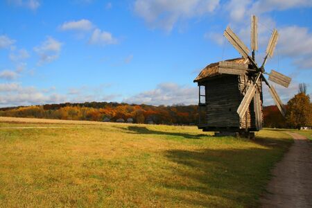 Windmills on the meadow, autumn vivid landscapeの写真素材