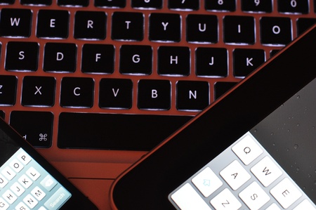 Various keyboards taken on top of each other with a red glowの写真素材