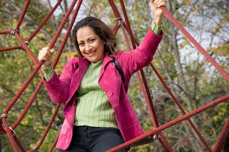 Grown up woman having fun like a kid at the parkの写真素材