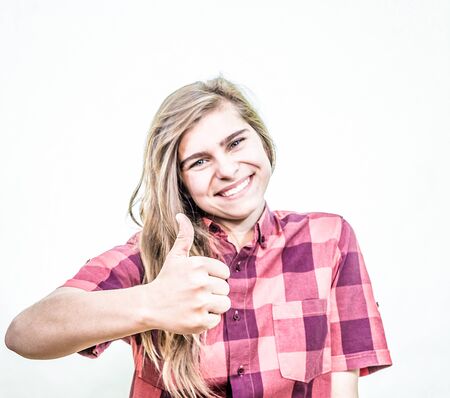 Teenage girl is showing thumbs up showing a nice, happy and supportive attitude.の写真素材