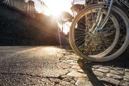 Two bikes against a beautiful sunset in Rome.の写真素材