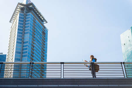 Beautiful girl looking at the map of the city.