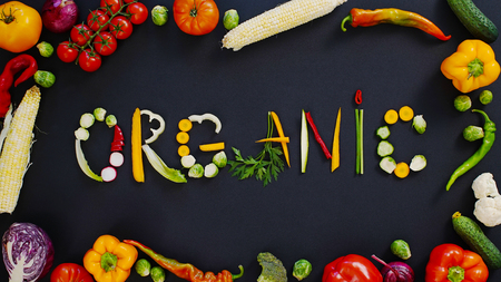 Vegetables on a black background. Word organic on a black background. Vegetables made word organic.の写真素材