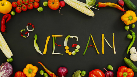 Word go vegan on a black background. Vegetables made word go vegan. Vegetables on a black background.の写真素材