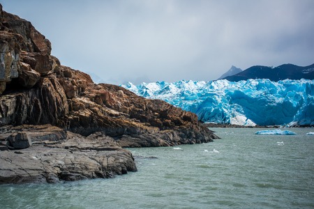 A blue glacier near a rocky shore. Shevelev.の写真素材