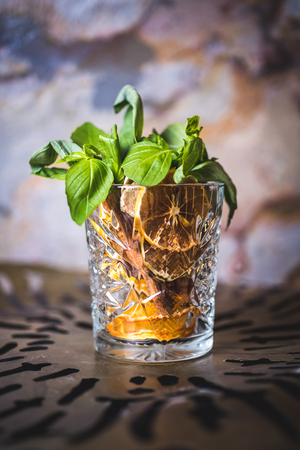 Lemon and mint in a glass with alcohol.の写真素材