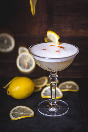 Lemon slices fall into a cocktail.の写真素材