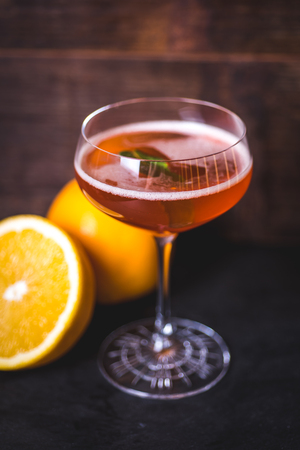 A glass with a drink and a sheet of mint.の写真素材