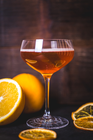 Oranges are reflected on the glass of a glass with a drink.の写真素材