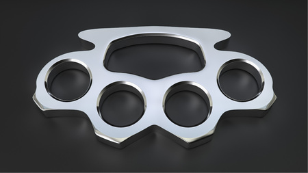 Chrome knuckle duster in a simple black studio space.の写真素材