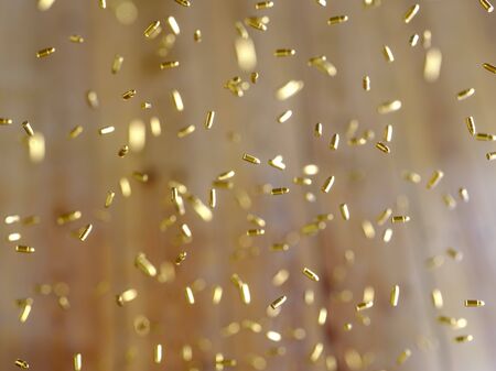 Swarm of gold pistol rounds floating in space with a shallow depth of field and an unidentifiable background. This image is a 3d renderingの写真素材