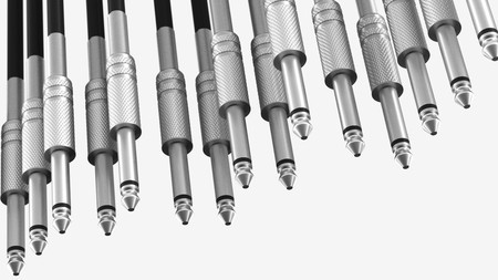 Hanging array of knurled metal 6mm audio connectors against a white background. This image is a 3d...