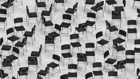 Steel and black leather chairs variously arranged on a tiled wooden floor without colors. This image is a 3d render.の写真素材